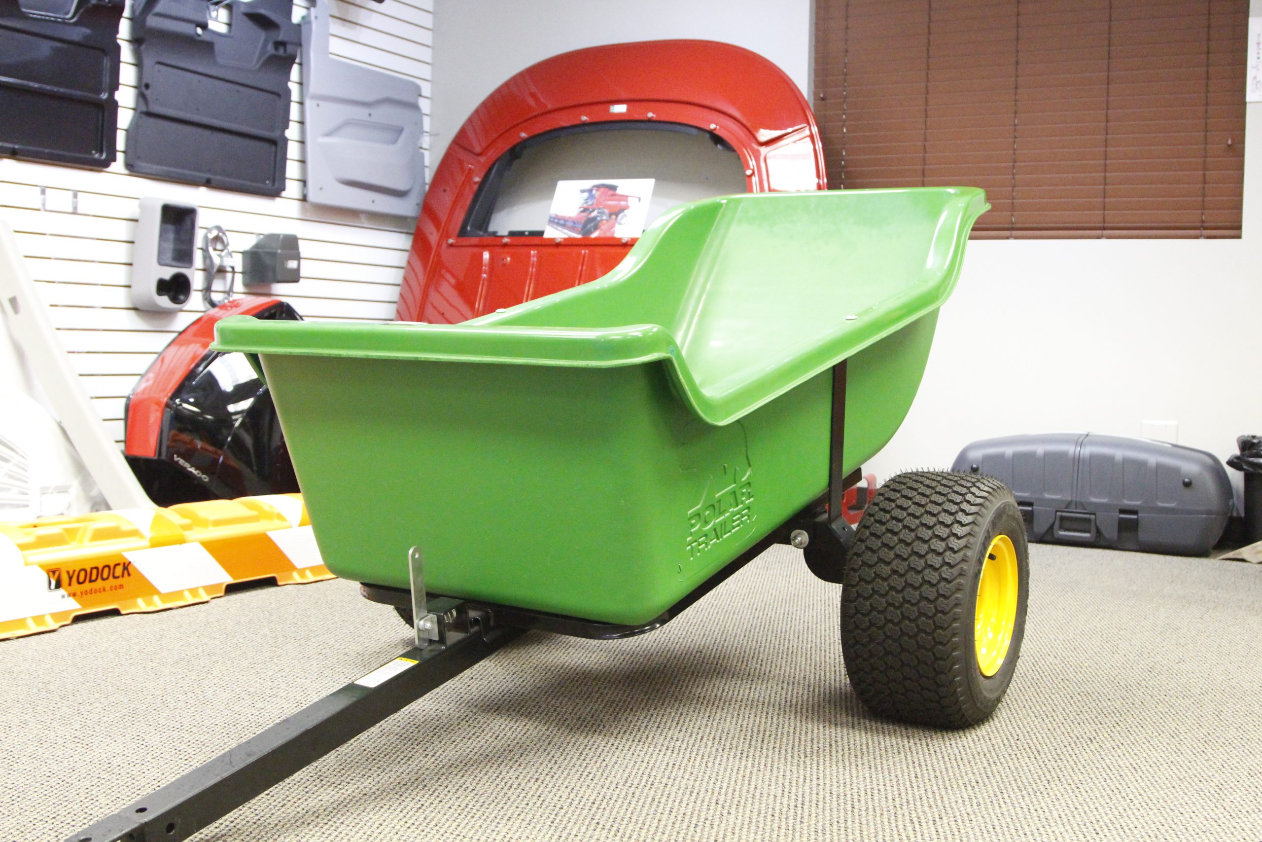The right custom plastic parts manufacturers can assist with unique part production, such as this green lawncare cart